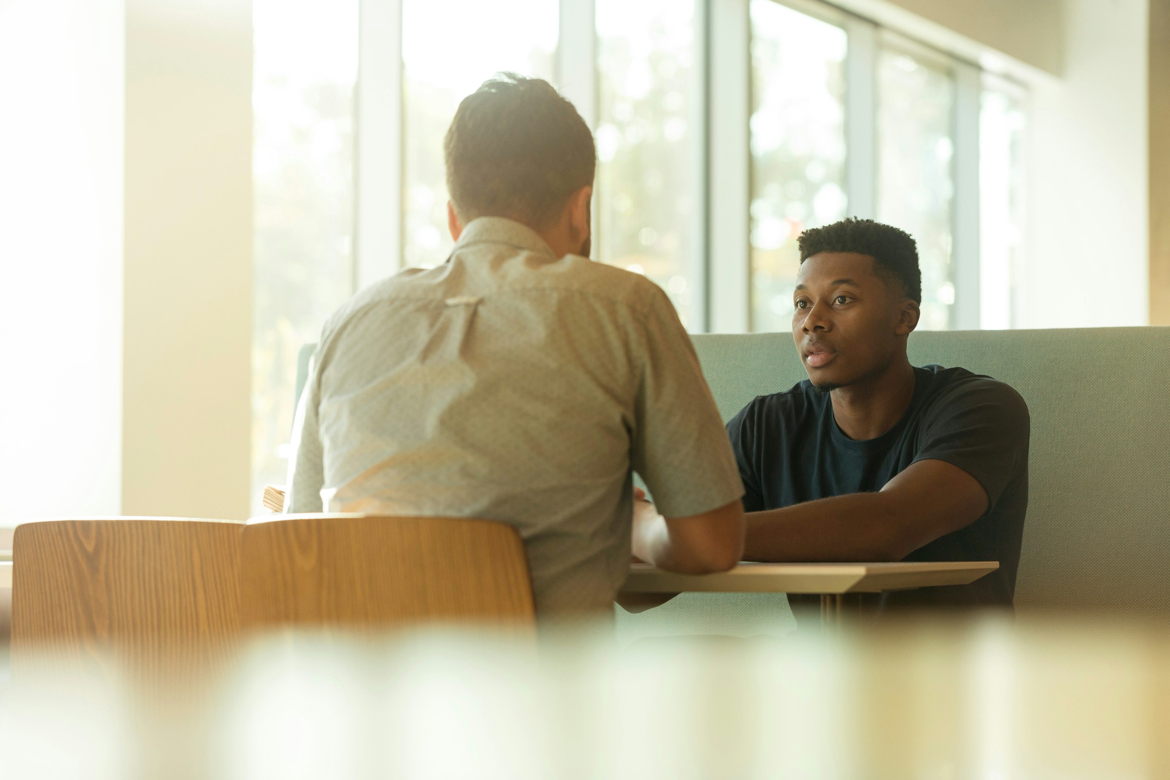 Two people in a direct conversation across a table